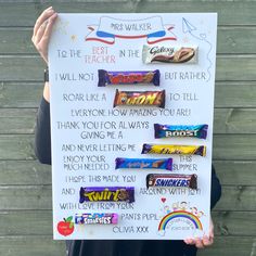 a person holding up a sign with candy on it