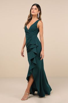 We can't imagine a better way to look truly elegant than with the Lulus Pure Loveliness Emerald Pleated Ruffled High-Low Maxi Dress! This sensational, crepe knit gown features a lightly pleated bodice and a flirty surplice neckline (and V-back), all supported by wide shoulder straps. Flouncy ruffle trim starts at the high, fitted waist and continues down the figure-flaunting skirt as it falls to a trendy, high-low maxi hem. Hidden back zipper/clasp. Fit: This garment fits true to size. Length: F Elegant V-neck Maxi Dress With Ruffled Skirt, Ruffled V-neck Maxi Dress For Gala, Elegant Green V-neck Ruffle Dress, Evening Floor-length Dress With Ruffled Skirt, Evening Dresses With Ruffled Floor-length Skirt, Floor-length Evening Dress With Ruffled Skirt, Floor-length Ruffled Evening Dress, V-neck Gown With Ruffles For Gala, Formal V-neck Gown With Ruffles