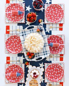 red, white and blue desserts are arranged on patriotic placemats with utensils