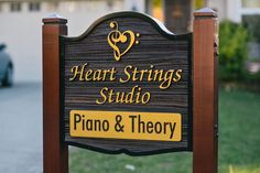 a wooden sign that says heart strings studio piano & theory