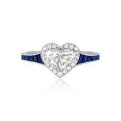 This stunning ring features a 1.00 carat heart-shaped diamond center stone. Surrounding the center diamond is a halo of micro-pave set diamonds. Adorning the shank are French-cut sapphires. The total sapphire weight is 0.65 carats. Fine milgrain and an additional row of round brilliant cut diamonds adorn the platinum mounting. The total weight of the additional diamonds is 0.18 carats.
The measurements of this ring including the diamond halo are approximately 8.87mm x 9.53mm.
This ring is curren Diamond White Heart Cut Diamond Ring With Halo Setting, Heart Cut Diamond White Diamond Ring With Halo Setting, Heart Cut Platinum Diamond Ring, Heart Cut Cubic Zirconia Halo Ring, Heart Cut Diamond Halo Ring, Diamond Heart Cut Halo Ring, White Heart Cut Brilliant Ring, Platinum Heart Cut Ring With Halo Setting, Luxury Heart Cut Diamond Ring With Halo Design