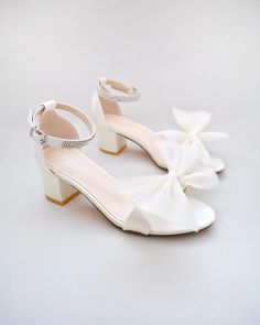 Shop our collection of women shoes for evenings and weddings in satin, lace, and glitter. Heels, flats, and dress sandals available for brides, bridesmaids and other special events. FREE SHIPPING IN U.S FOR ORDERS $150 AND MORE! Grad Heels Grade 8, Prom Sandals With Satin Bow And Open Toe, Summer Prom Sandals With Satin Bow, Prom Sandals With Bow And Block Heel, Ankle Strap Tulle Heels For Parties, Block Heel Sandals With Bow For Prom, Tulle Ankle Strap Heels For Party, Party Sandals With Satin Bow And Block Heel, Open Toe Tulle Heels For Party