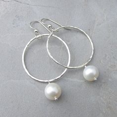 "White Pearl Gold Hoop Earrings~ These simple gold hammered hoops with white freshwater pearls are elegant for that special occasion yet perfect for everyday wear. You're sure to get plenty compliments while wearing these gorgeous earrings! Choose from 1\" or 1.5\" hoops Also available in sterling silver~ https://www.etsy.com/listing/269038144/white-pearl-earrings-silver-hammered?ref=listing-shop-header-0 Shop~ http://www.etsy.com/shop/HanaMauiCreations?ref=pr_shop_more International buyers plea Silver Hoop Earrings With Pearl Charm For Wedding, Hammered Pearl Jewelry For Wedding, Hammered Round Wedding Earrings, White Hammered Jewelry For Anniversary, Hand Forged Wedding Earrings, Hand Forged White Jewelry For Wedding, White Hammered Dangle Jewelry, Silver Small Hoop Pearl Earrings For Wedding, Elegant Hammered Pearl Earrings For Wedding