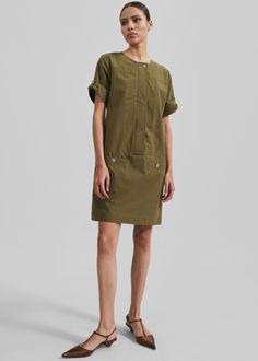 Color: Dark Olive Midweight cotton fabric Regular fit Mini length Crewneck Adjustable sleeve cuffs Front welt pockets Back panel with snap button closure Concealed front button placket Unlined 100% Cotton Dry Clean By Proenza Schouler White Label. Imported The Frankie Shop Dress, Watson Mini Dress, Boxy Dress, Frankie Shop, White Label, Proenza Schouler, Button Placket, Welt Pockets, Welt Pocket