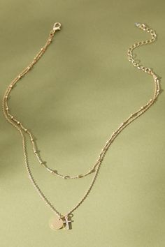 This dainty, layered cross necklace features a cross and small pendant, as well as some gold beading. We love this necklace with a low neckline top or dress for a sweet and feminine addition to any outfit! Delicate Gold Layered Chain Necklace, Low Neckline Top, Layered Cross Necklace, Dainty Cross Necklace, Layered Crosses, Low Neckline, Small Pendant, A Cross, Altar'd State