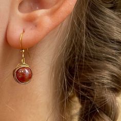 Red Acrylic Wrapped Gold Bead Earring made with gold iron wire wrapped delicately around a acrylic bead. All earrings here are crafted with love and care 🥰 These are the perfect earrings for a thoughtful gift or a way to treat yourself. The earrings are simple and designed to make you shine ✨ 14k Gold Filled Beaded Earrings For Gift, 14k Gold Filled Beaded Earrings As Gift, Wire Wrapped Beaded Earrings As Gift, Red Copper Wire Wrapped Jewelry, Red Copper Wire Jewelry Gift, Red Wire Wrapped Copper Jewelry, Single Round Beaded Earring As A Gift, Gift Round Beaded Single Earring, Nickel-free Copper Wire Earrings As Gift