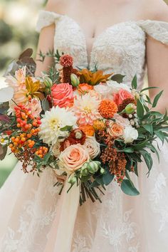 A fall bridal bouquet with dahlias, roses, and orange berries. Fall Wedding Bouquets October, Autumn Bridal Bouquet, Fall Bridal Bouquet, Bridal Bouquet Fall, Peach Roses, Lush Greenery