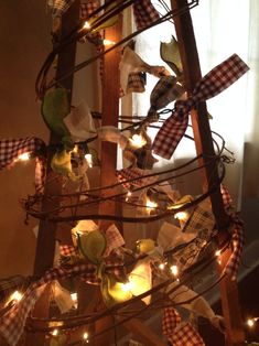 a christmas tree decorated with plaid ribbon and lights