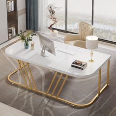 a white and gold coffee table with a laptop on it in front of a large window