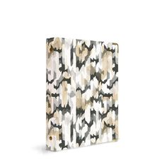 an ipad case with a pattern on the front and back cover in beige, black and white