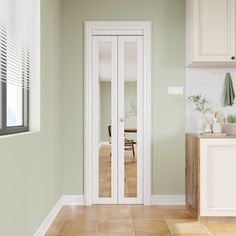 a kitchen with green walls and white cabinets