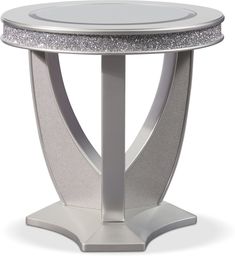 a round table with silver glitter on the top and an oval metal base, in front of a white background