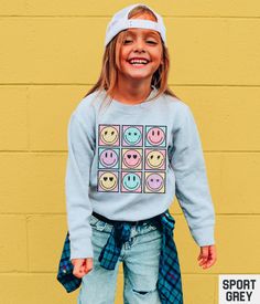 Our retro smiley face graphic sweatshirt features a vintage inspired pastel happy face grid design. Our crewneck pairs perfectly with other matching size and style variations (linked below). ✩ ✩ 𝗧𝗼𝗱𝗱𝗹𝗲𝗿 𝗕𝗲𝗹𝗹𝗮 𝗖𝗮𝗻𝘃𝗮𝘀 𝗧𝗲𝗲: https://starrieapparel.etsy.com/listing/1749559772 ✩ 𝗞𝗶𝗱𝘀 𝗕𝗲𝗹𝗹𝗮 𝗖𝗮𝗻𝘃𝗮𝘀 𝗧𝗲𝗲: https://starrieapparel.etsy.com/listing/1749558620 ✩ 𝗞𝗶𝗱𝘀 𝗖𝗼𝗺𝗳𝗼𝗿𝘁 𝗖𝗼𝗹𝗼𝗿𝘀 𝗧𝗲𝗲: https://starrieapparel.etsy.com/listing/1749557888 ✩ 𝗞𝗶𝗱𝘀 𝗦𝘄 Smiley Face Sweatshirt, Trendy Shirt Designs, Face Graphic, Trendy Boho, Grid Design, Bella Canvas Tees, Comfort Colors Tee, Girl Sweatshirts, Happy Face