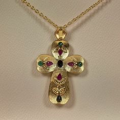 Byzantine style Greek Cross made of 18 carat solid yellow gold with genuine precious gemstones The Cross is decorated with different shapes Rubys,Sapphires,Emeralds and a Diamond 0.10 ct. Total weight of te colored stones is 3.20 ct. The specific Croos has been manufactured in one of the oldest jewelry workshops in Athens which is famous for production of byzantine jewelry It is a handmade Cross with spirals and grains Made in Greece inspaired by Byzantine art jewelry A beautiful piece of jewelr Gold Byzantine Jewelry With Multi-stone, Gold Byzantine Multi-stone Jewelry, Byzantine Multi-stone Jewelry As Gift, Gold Byzantine Jeweled Jewelry, Byzantine Jeweled Gold Jewelry, Byzantine Style Jeweled Gold Jewelry, Byzantine Jewelry, Ancient Greek Coin, Clip On Charms