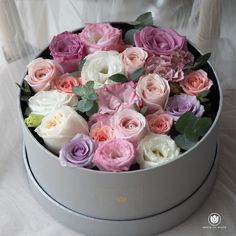 a white box with pink and purple flowers in it