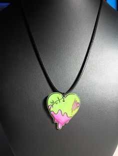 Frankenstein heart pendant with adjustable rope necklace. Pendant made of acrylic. Adjustable Trendy Heart Pendant Necklace, Trendy Adjustable Heart Pendant Necklace, Adjustable Trendy Heart Choker Necklace, Casual Heart Necklace With Heart Pendant, Trendy Adjustable Heart Choker Necklace, Casual Heart Charm Necklace For Gift, Casual Heart Charm Necklace For Valentine's Day, Trendy Adjustable Heart Charm Necklace, Casual Heart Pendant Necklace For Valentine's Day