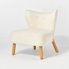 an upholstered chair with wooden legs on a white background