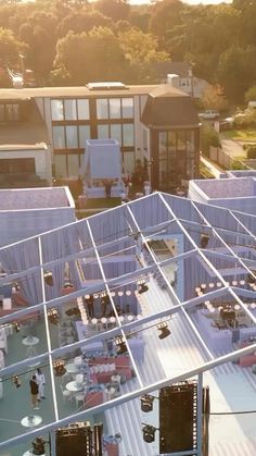 an aerial view of the roof of a building with many tables and chairs on it