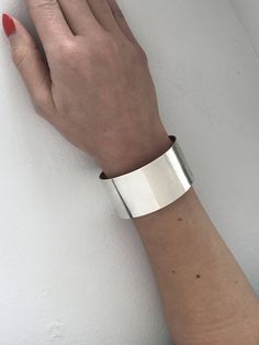 "Chunky 40.84 Gram Retro Westcoasters 925 Silver Cuff. Modern minimalist inspired design featuring a smooth uniformed 1 1/4\" band cuff. Does have some flex and can be adjusted in size up or down a little. Lightly cleaned ready to wear. Markings: Sterling, Westcoasters, MK Measurements: Approx size 7\" Total inside circumference including the wrist opening, 2 3/8\" inside diameter across, 1 1/8\" wrist opening, over 1 1/4\" wide all the way around. Total Weight: 40.87 grams Condition: Good Vinta Modern Polished Cuff Bangle, Modern Cuff Bangle With Polished Finish, Modern Sterling Silver Cuff Bracelet, Modern Sterling Silver Cuff Bracelet For Formal Occasions, Sterling Silver Cuff Bracelet, Sterling Silver Cuff, Silver Cuff Bracelet, Photo Bracelet, Vintage Bracelets