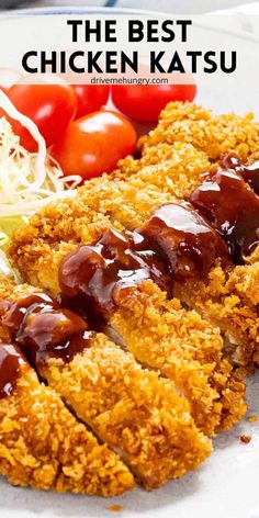 the best chicken katsu is served on a plate with tomatoes and lettuce