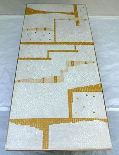 a white table with yellow and brown designs on it