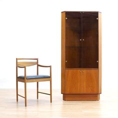 a wooden cabinet and chair next to each other