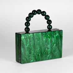 Discover elegance with our acrylic clutch, available in timeless white and vibrant green. Each clutch features a sophisticated top handle, blending style and functionality seamlessly. Elevate your accessory with these chic essentials that effortlessly complement any ensemble. Green Rectangular Box Bag For Party, Trendy Green Box Bag For Party, Green Rectangular Box Bag For Evening, Rectangular Green Box Bag For Evening, Green Clutch Box Bag For Gifts, Green Clutch Box Bag As Gift, Luxury Green Rectangular Clutch, Green Rectangular Evening Bag, Luxury Green Rectangular Evening Bag