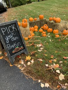 hay bales filled with pumpkins sitting next to a sign that says pick your own pumpkin farm