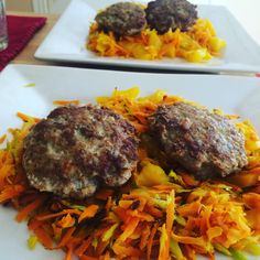 two white plates topped with meat patties covered in carrots and sauerkraut