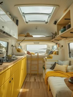 the interior of a small camper with yellow furniture and wood flooring is shown