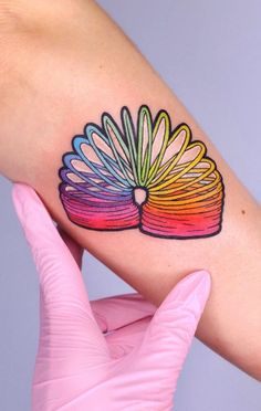 a woman's arm with a colorful tattoo on it