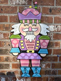 a wooden sign with an image of a nutcracker on it's face