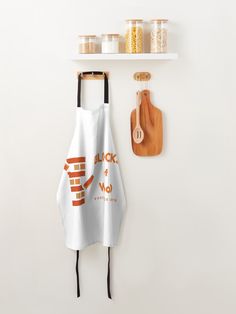 a kitchen towel hanging on the wall next to a cutting board and utensils