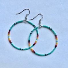 These handmade, beaded hoop, earrings come in a variety of colors. This is a gorgeous teal sunset pattern. Perfect for all occasions and super comfortable to wear. These earrings are not heavy at all and can be worn comfortably all day. The earrings are 5 cm across. Every pair is unique and  may look somewhat different than the picture. I love making these earrings and hope you enjoy wearing them! Handmade Beaded Hoop Earrings For Beach, Handmade Hoop Beaded Earrings For Beach, Everyday Blue Beaded Hoop Earrings, Handmade Turquoise Hoop Earrings For Beach, Turquoise Bohemian Hoop Earrings For Beach, Blue Bohemian Hoop Earrings With Tiny Beads, Bohemian Blue Hoop Earrings With Tiny Beads, Bohemian Turquoise Hoop Earrings For Beach, Bohemian Beaded Hoop Earrings For Everyday