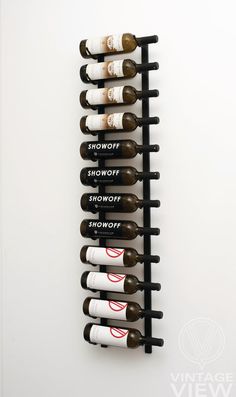 a wall mounted wine rack with six bottles