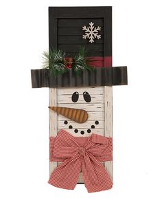 a snowman door hanger with a bow on it