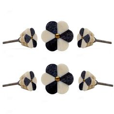 four pairs of black and white flower hair pins with gold accents on each one side