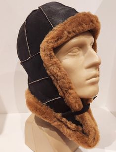 Classic Windproof Hat For Outdoor, Winter Windproof Leather Hat, Brown Windproof Beanie Hat, Adjustable Windproof Aviator Hat, Winter Leather Windproof Hat, Leather Windproof Hats For Outdoor Use, Black Aviator Hat For Outdoor, Winter Outdoor Fur Felt Hat, Winter Black Sheepskin Hats