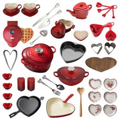 a collection of kitchen utensils and heart shaped dishes