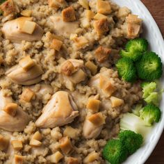 a white plate topped with rice and chicken next to broccoli