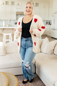 Fall in love with the Heart Eyes Cardigan! This mid-weight sweater knit envelopes you in a longline fit, while the knit red hearts add a pop of color. With an open front, this cardigan is perfect for layering and keeping you cozy. (You'll heart this addition to your wardrobe!) Mid-Weight Sweater Knit Dropped Shoulder Knit Hearts Ribbed Trim Longline Fit 100% Polyester True to Size S: Chest 44" Length 28"M: Chest 46" Length 28"L: Chest 48" Length 28"XL: Chest 50" Length 29"1XL: Chest 52" Length 2 Cozy Slippers, Knitted Heart, Slippers Cozy, Judy Blue Jeans, Red Hearts, Mini Heart, Heart Eyes, Cardigan Tops, Sweater Knit