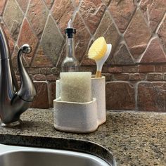 a soap dispenser sitting on top of a counter next to a sink