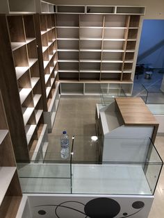 an empty library with glass shelves and bookshelves