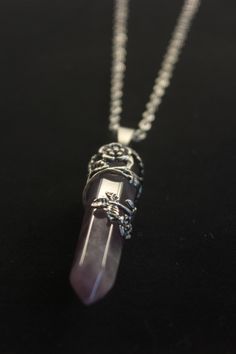 Beautiful natural Amethyst  stone necklace.   Amethyst  is a semiprecious violet stone that is often used in jewelry and for healing purposes. It has been sought after throughout the ages for its stunning colors and ability to stimulate the mind and emotions. The most powerful and popular healing stone.  This crystal is wrapped in a delicate flower and adorned by a durable stainless 20 inch yoga chain. Amethyst Jewelry Aesthetic, Purple Necklace With Large Stone For Gift, Purple Amethyst Pendant Crystal Necklace, Amethyst Round Pendant For Healing, Spiritual Purple Pendant Necklace, Purple Gemstone Crystal Pendant Necklace, Mystical Amethyst Necklace For Gift, Spiritual Amethyst Round Pendant Necklace, Purple Amethyst Wire Wrapped Crystal Necklace