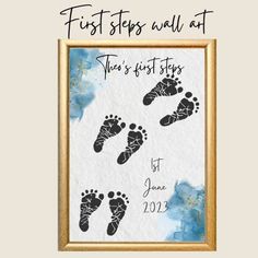 the first steps wall art is displayed in a gold frame with blue watercolor paint