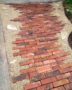 a red brick walkway in front of a house