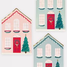 three paper houses with christmas decorations on the front and side, each decorated in different colors