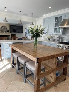 a kitchen island with stools in front of it