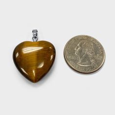 Natural Tiger Eye Heart Pendant with Stainless Steel Bail. Our unique Heart Shaped Pendants are made with high quality Tiger Eye stone and precious Stainless Steel metal at a price point that works for you because everyone deserves a piece of luxury. Each item arrives in a classic box for a nice gift presentation and storage. The image may show slight differences to the actual stone in color and texture. Please allow a slight color difference! Gift Presentation, Tiger Eye Gemstone, Tiger Eye Crystal, Crystal Heart Pendant, Bear Pendant, Tigers Eye Gemstone, Heart Shape Pendant, Tiger Eye Stone, Eye Stone