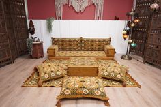 a living room filled with lots of furniture and rugs on top of hard wood flooring